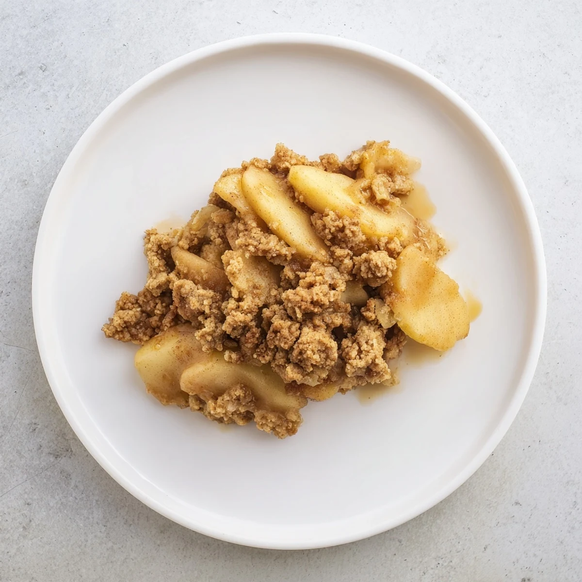 Golden-brown baked Warm Rustic Apple and Cinnamon Crumble, bubbling and ready to serve with ice cream.