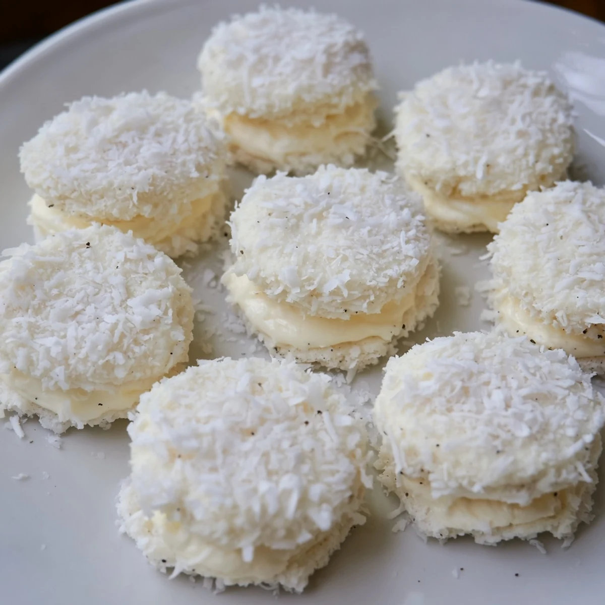 Freshly made snowball tea sandwich bites, bite-sized delights ready for a festive winter gathering.