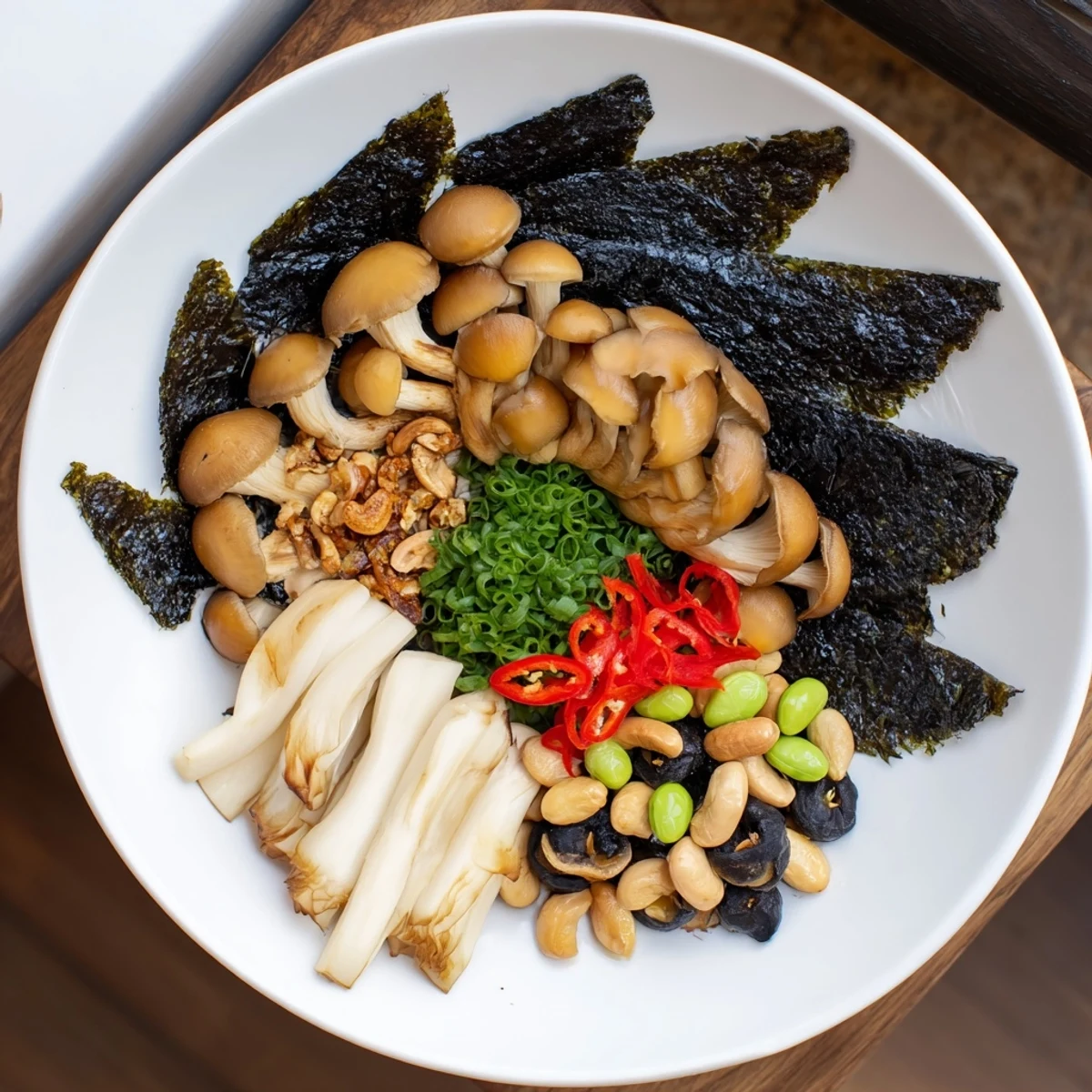 Artfully arranged Umami Bomb Asian Delight with mushroom fans, seaweed, and pickled components for a stunning visual.