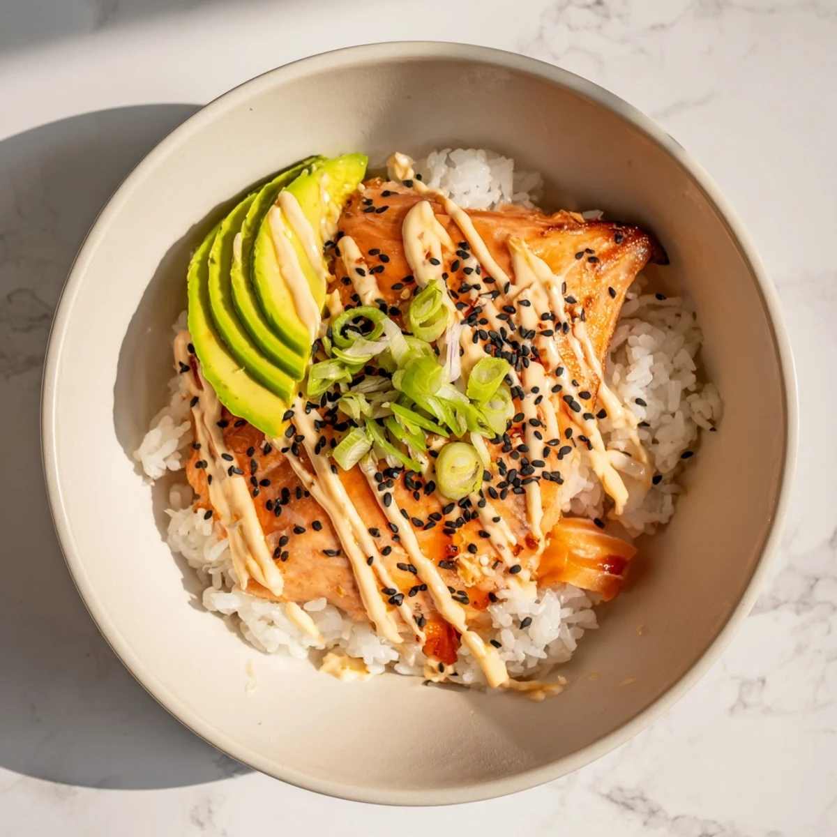 Flaky salmon nestled atop seasoned rice, this Classic Salmon Rice bowl is a quick, satisfying meal.