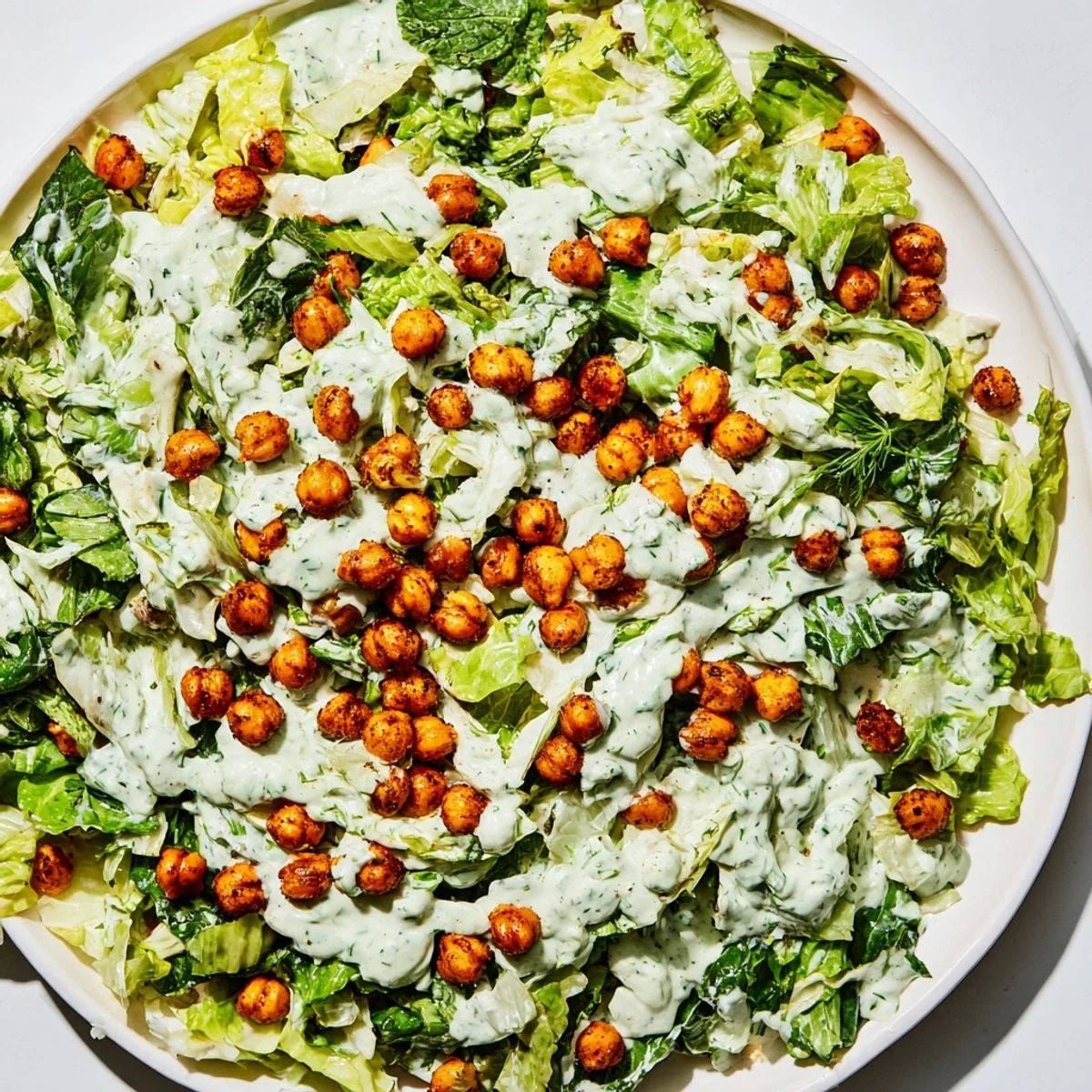 Green Goddess Salad with crispy chickpeas, a refreshing bowl of greens topped with crunchy, golden chickpeas.