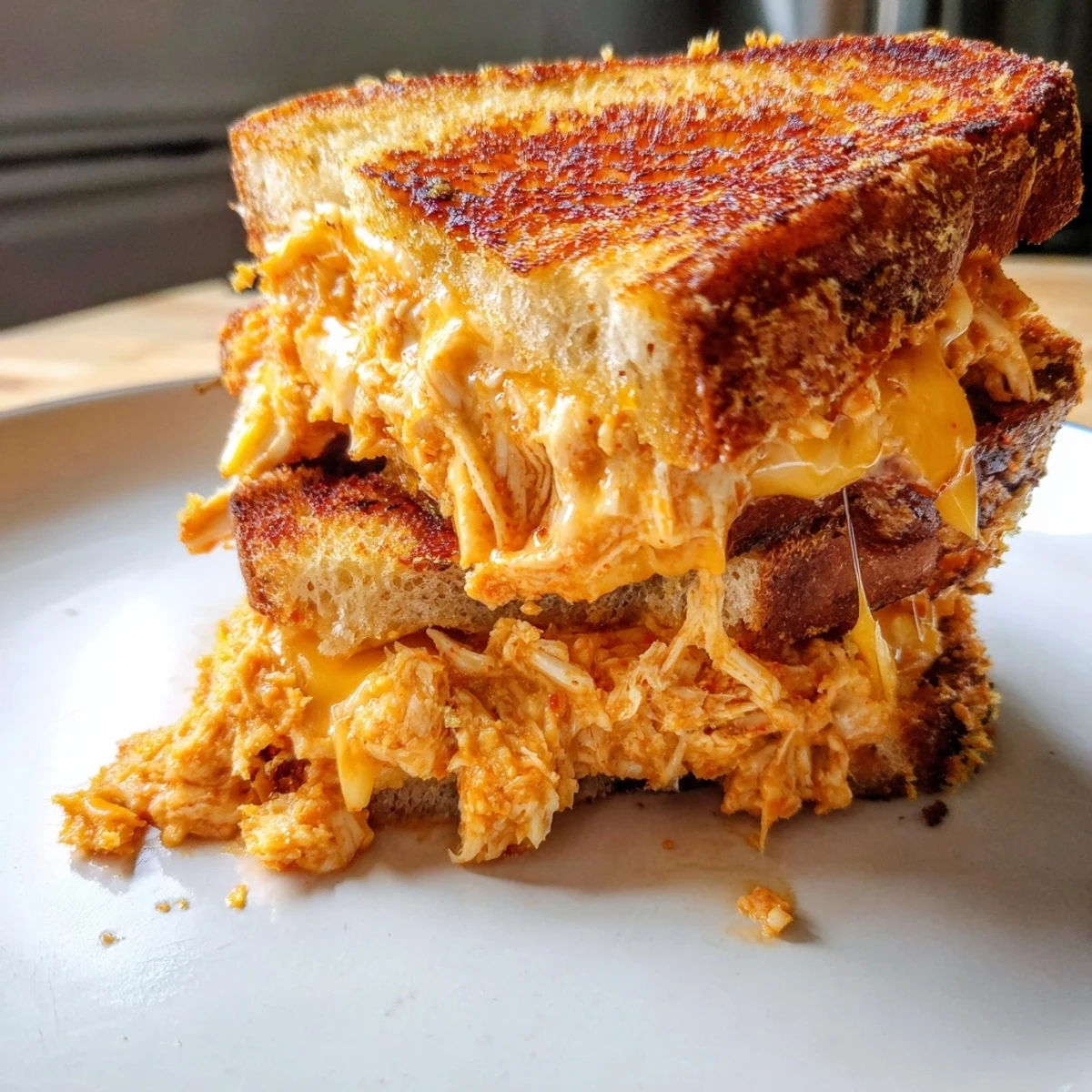 Golden, grilled Spicy Crispy Chicken Sandwich Grilled Cheese, oozing melted cheese and spicy chicken.