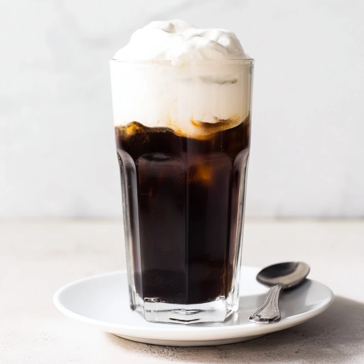 Fluffy Starbucks Cold Foam over iced coffee, showcasing its creamy vanilla sweetness and airy texture.
