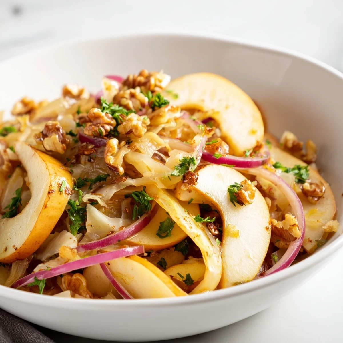 Warm Apple and Sauerkraut Skillet Salad with caramelized apples, onions, and toasted walnuts served warm in a skillet.