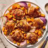 A vibrant Honey-Glazed Chicken with Roasted Root Vegetables dish, glistening with sweet honey sauce.