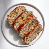 This juicy Everyday Herb-Sprigged Turkey Meatloaf showcases a perfectly caramelized ketchup glaze, enticing your appetite.