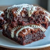 Chocolate brownie bites topped with white icing laces, designed to look like baseballs for game day celebrations.