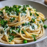 Bright and zesty ricotta-lemon linguine with vibrant green peas, tossed with garlic and Parmesan.  