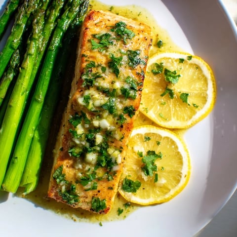 Golden, flaky Skillet Lemon-Butter Salmon with asparagus, ready for a delicious, healthy dinner tonight!
