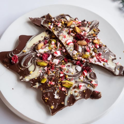 Holiday bark shards, a delicious medley of peppermint, pistachios, and cranberry atop dark chocolate.