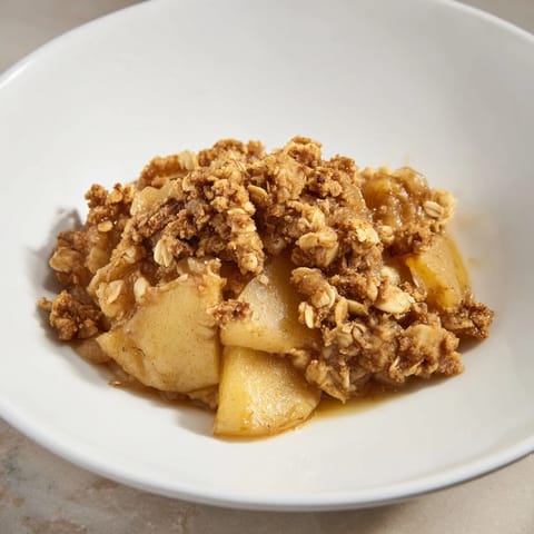 Freshly baked Warm Rustic Apple and Cinnamon Crumble, with a buttery crumble topping and cinnamon aroma.