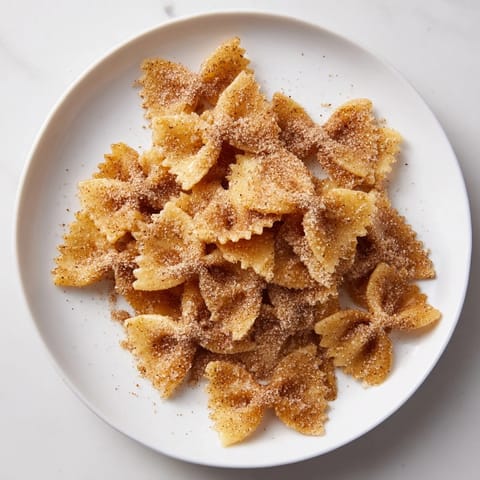 Bowtie pasta transformed into delicious Air Fryer Pasta Christmas Crack, coated with cinnamon sugar.