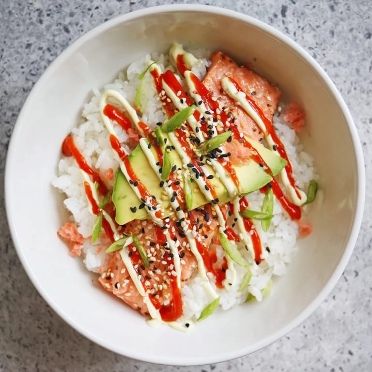 Creamy avocado slices and seaweed squares complement the delicious flavors in this Classic Salmon Rice dish.