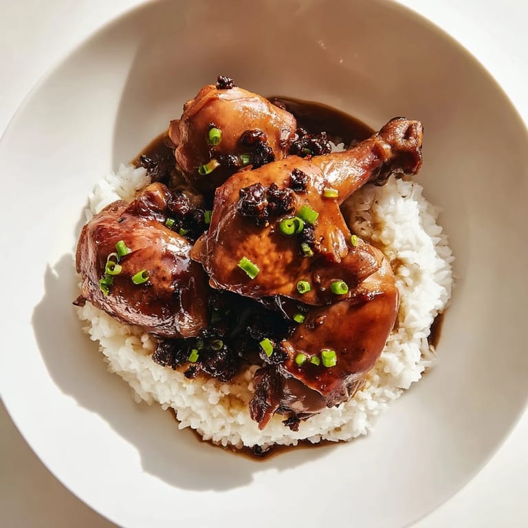 Tender chicken thighs simmered in a rich sauce, this Filipino Chicken Adobo is a comforting home-cooked meal.