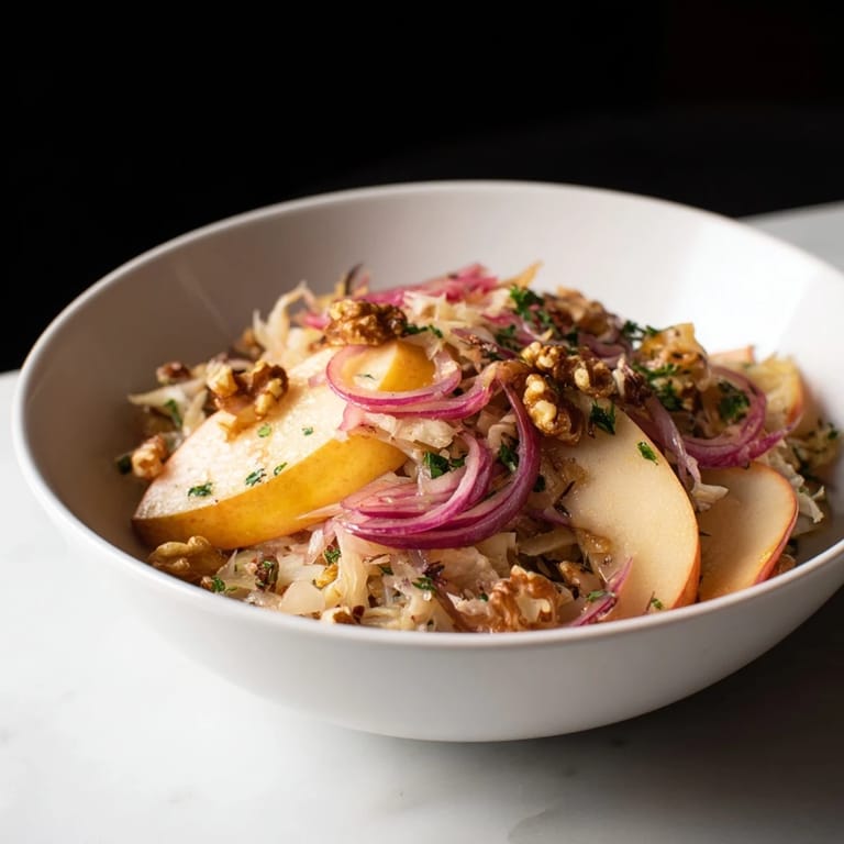 Sizzling sauerkraut and sweet apples in a skillet, creating a vibrant German-inspired salad ready to serve as a light main.