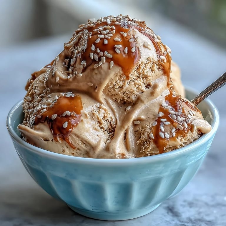 Homemade Japanese Hojicha Ice Cream served in a glass cup, showcasing its smooth, elegant texture and warm color.