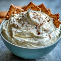 Creamy cheesecake dip with graham crackers, perfect for dipping and sharing at parties or dessert tables.